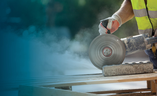 Mason cutting brick with a saw