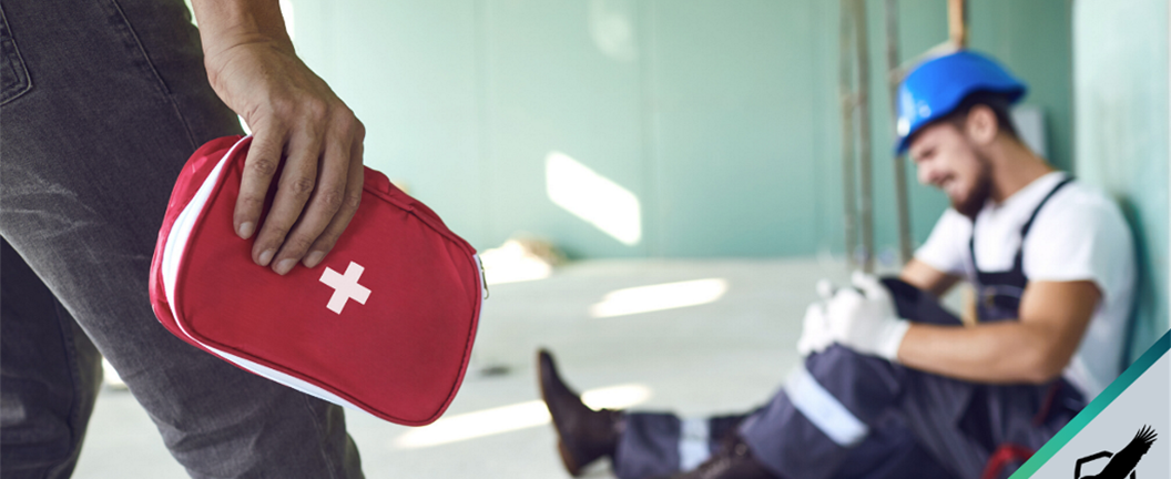 Man bringing first aid pack to injured construction worker