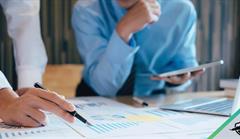 Workers going over graphs and charts