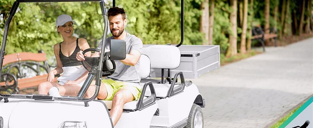 Couple driving a utility cart