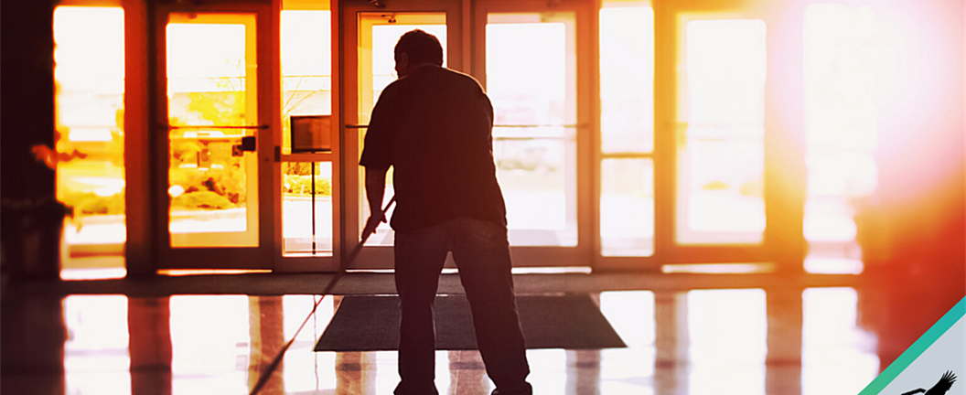 Janitor cleaning hallway