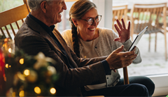 Couple using iPad to talk to family