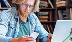 Man on laptop and phone